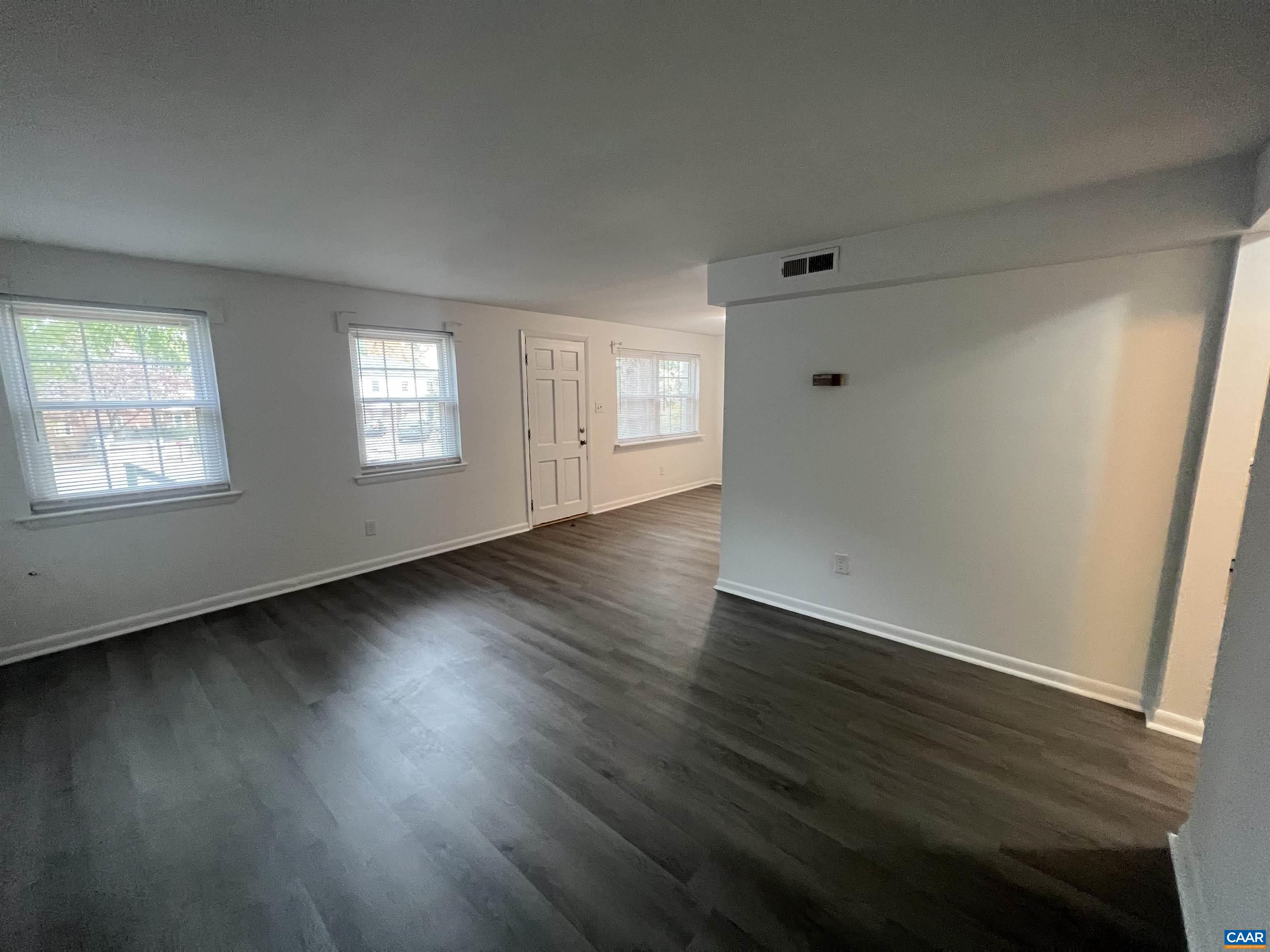 124 Middlesex Drive, Unit B Charlottesville, VA 22901 - Photo 27 of 38 a view of an empty room with wooden floor and windows