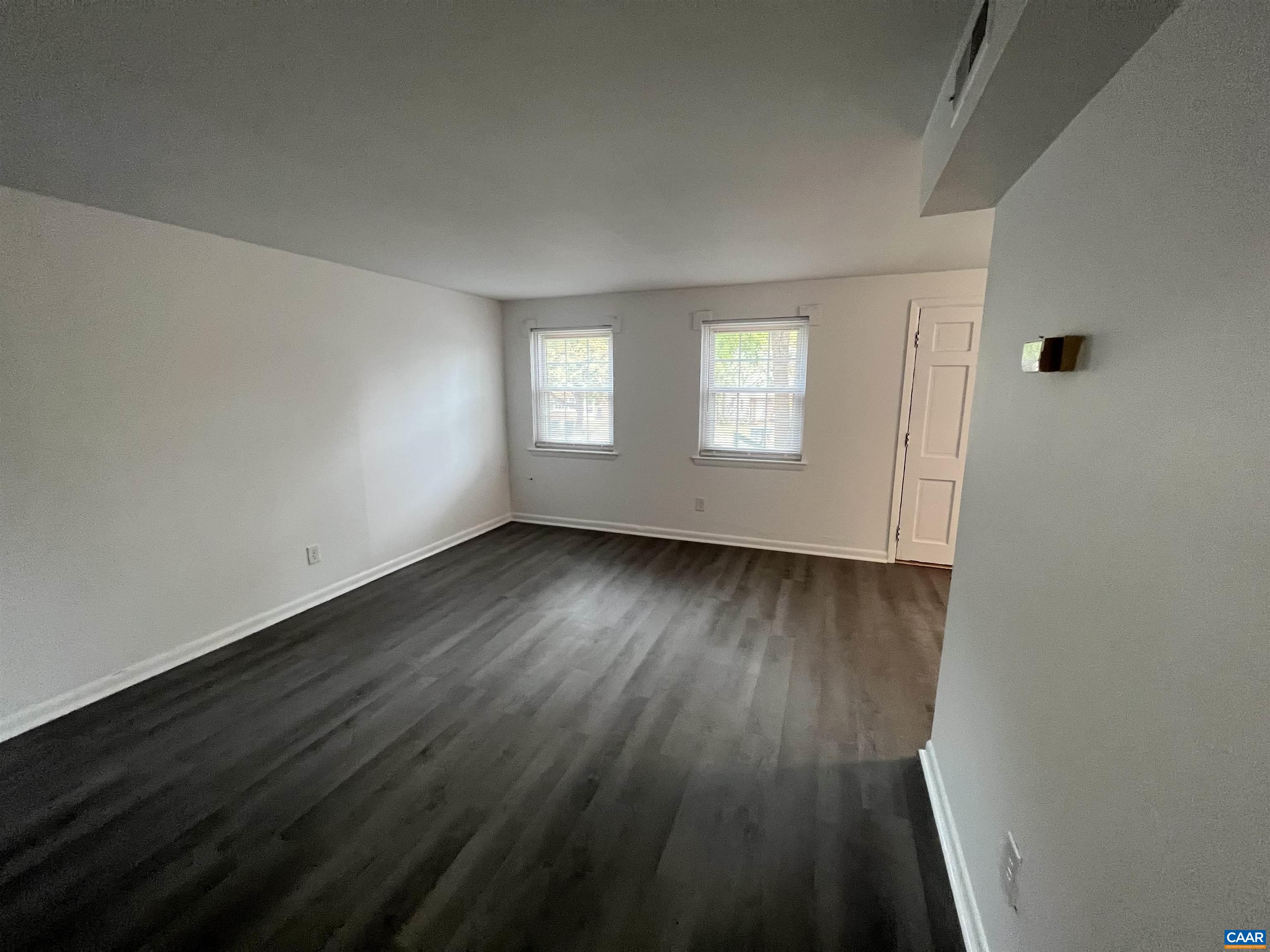 124 Middlesex Drive, Unit B Charlottesville, VA 22901 - Photo 28 of 38 an empty room with wooden floor and windows