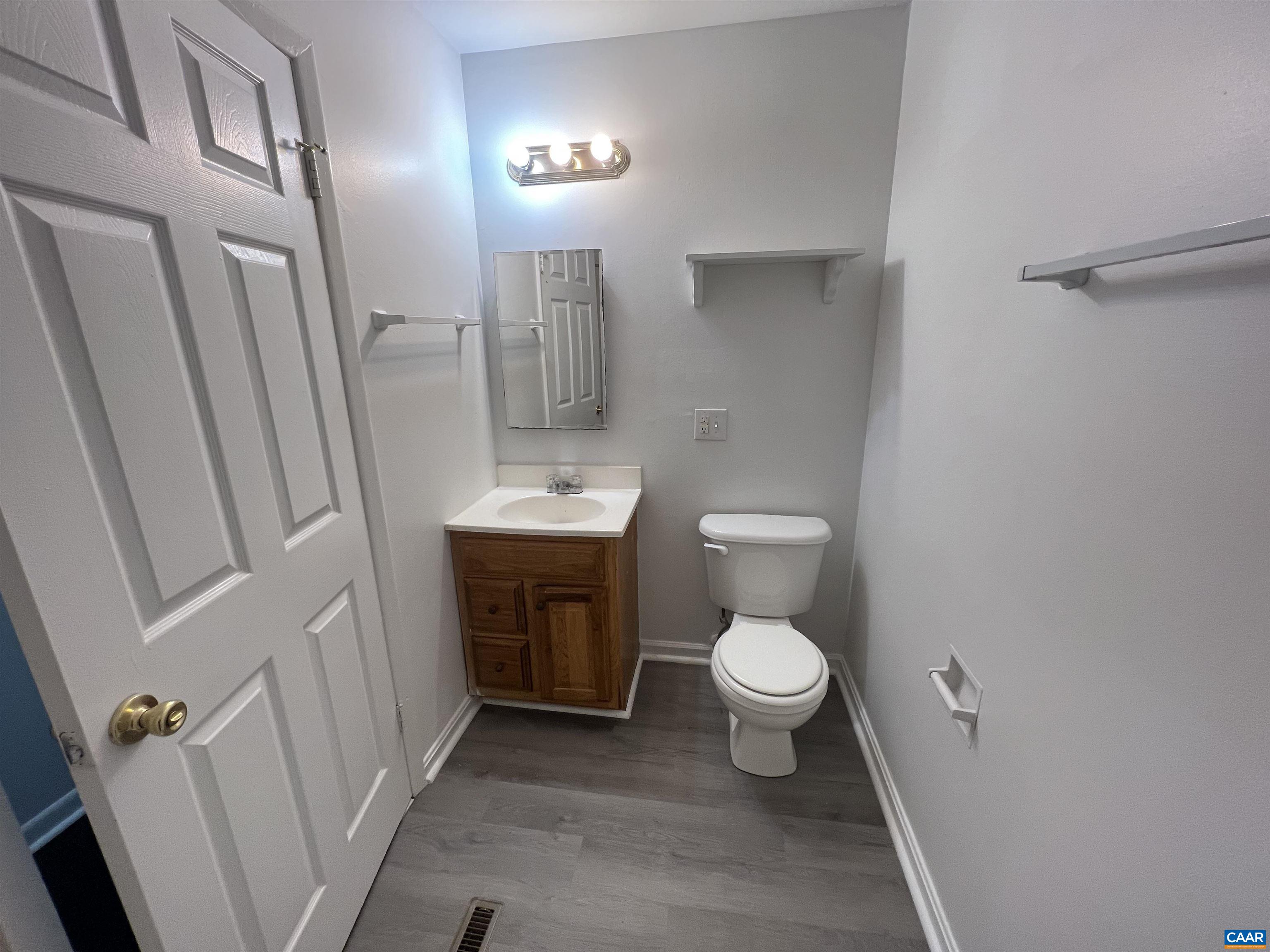 124 Middlesex Drive, Unit B Charlottesville, VA 22901 - Photo 34 of 38 a bathroom with a sink a toilet a mirror and vanity
