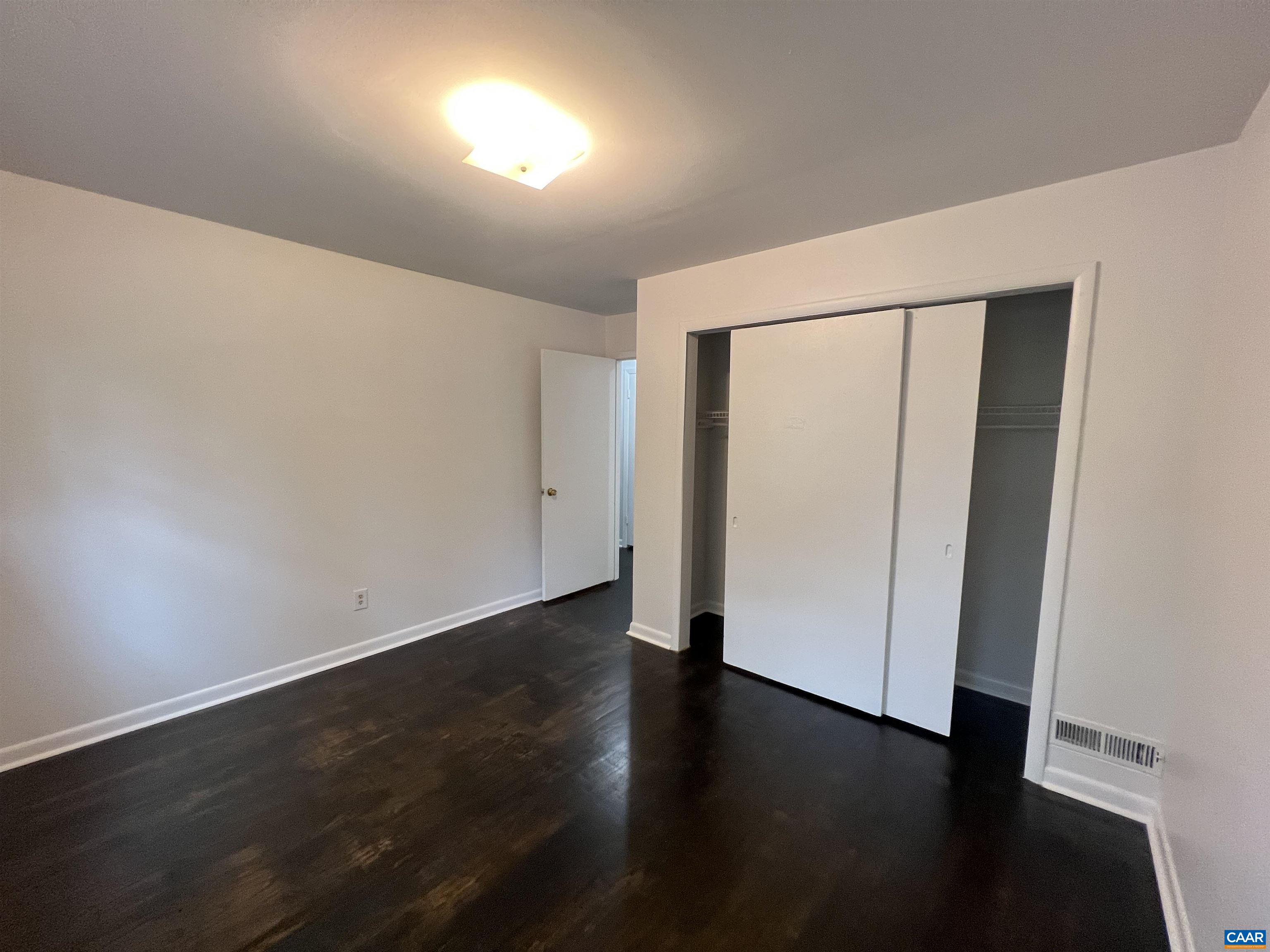 124 Middlesex Drive, Unit B Charlottesville, VA 22901 - Photo 4 of 38 an empty room with wooden floor