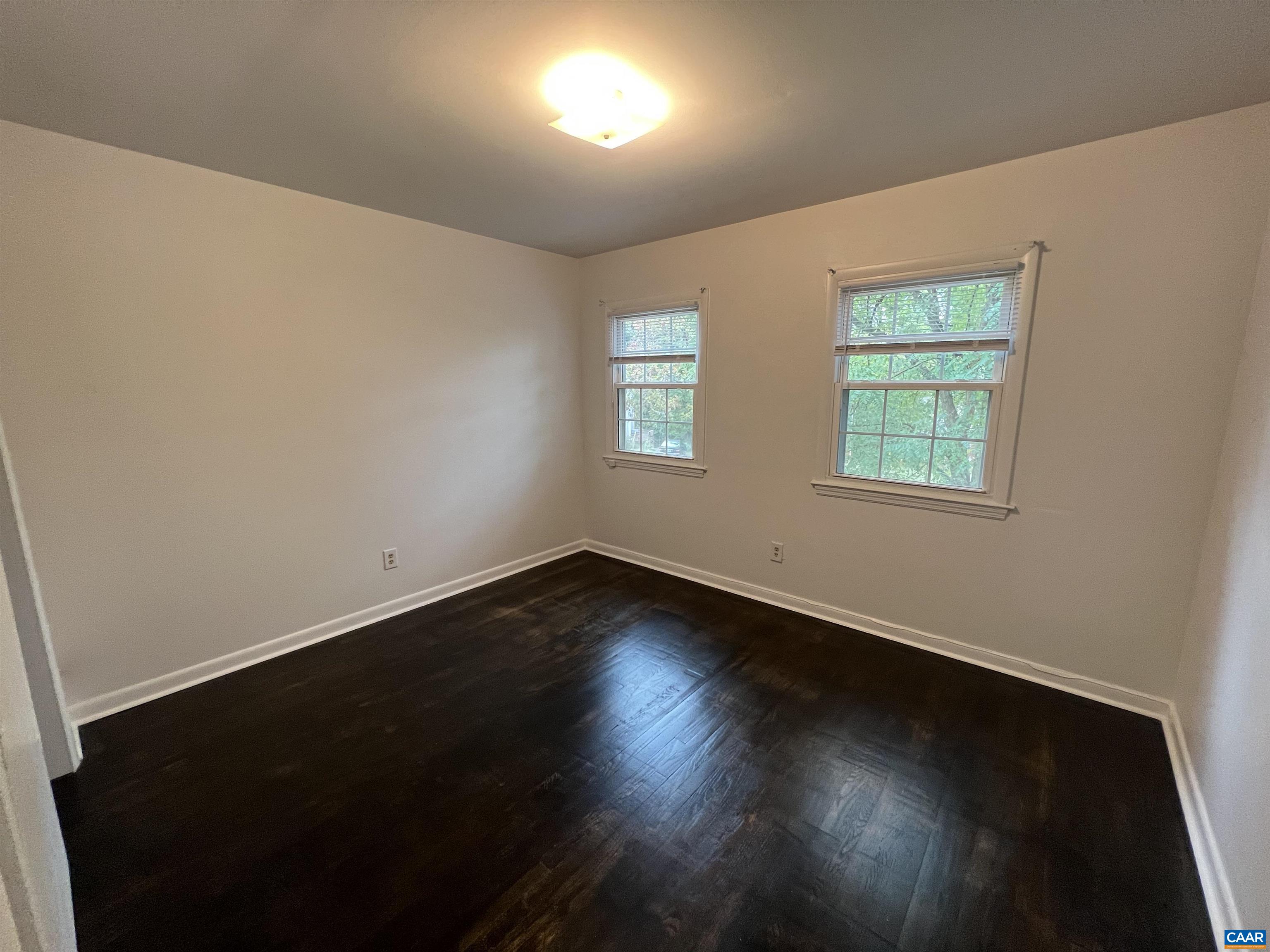 124 Middlesex Drive, Unit B Charlottesville, VA 22901 - Photo 5 of 38 a view of an empty room with wooden floor and a window