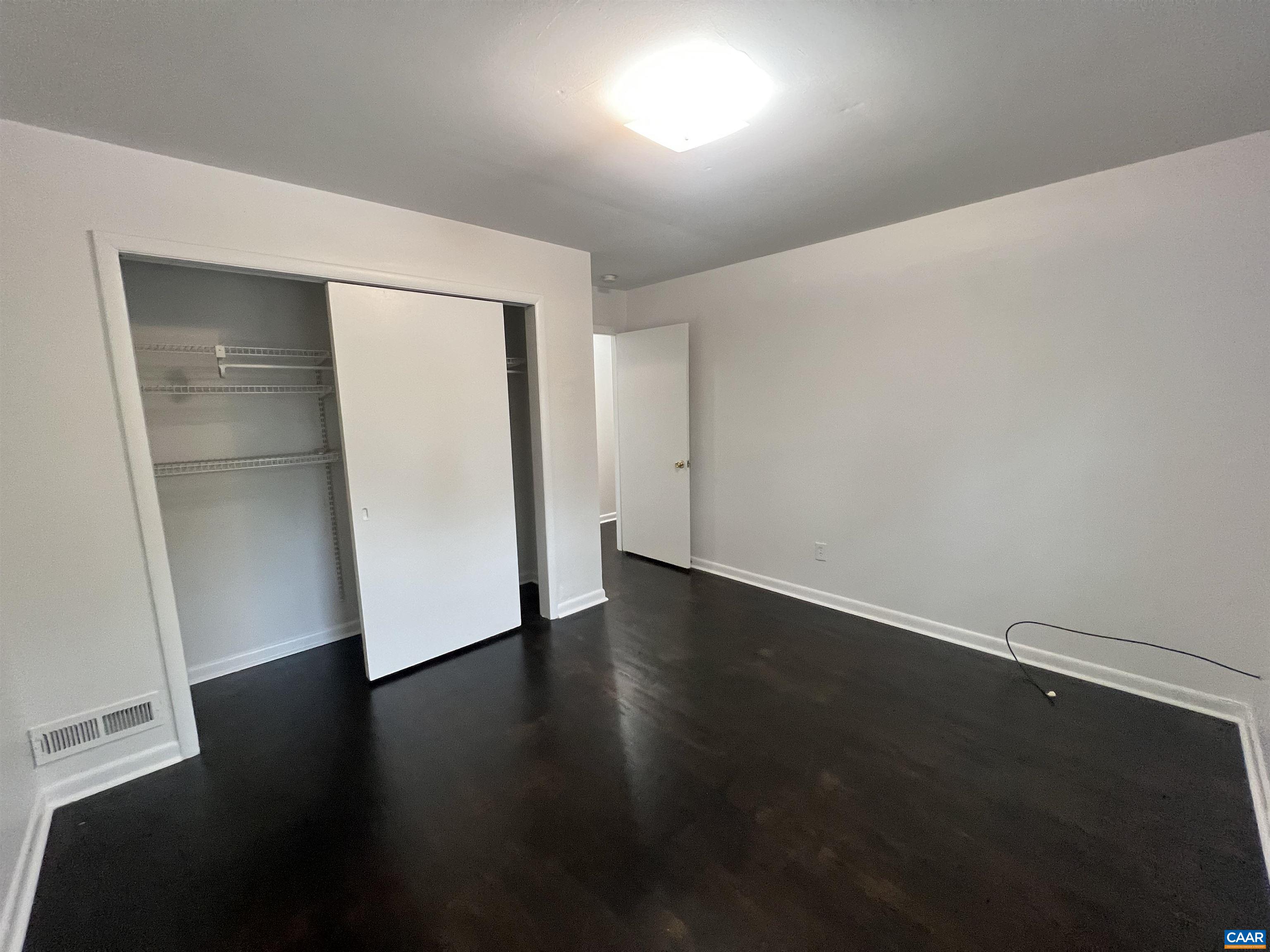 124 Middlesex Drive, Unit B Charlottesville, VA 22901 - Photo 6 of 38 an empty room with wooden floor and closet