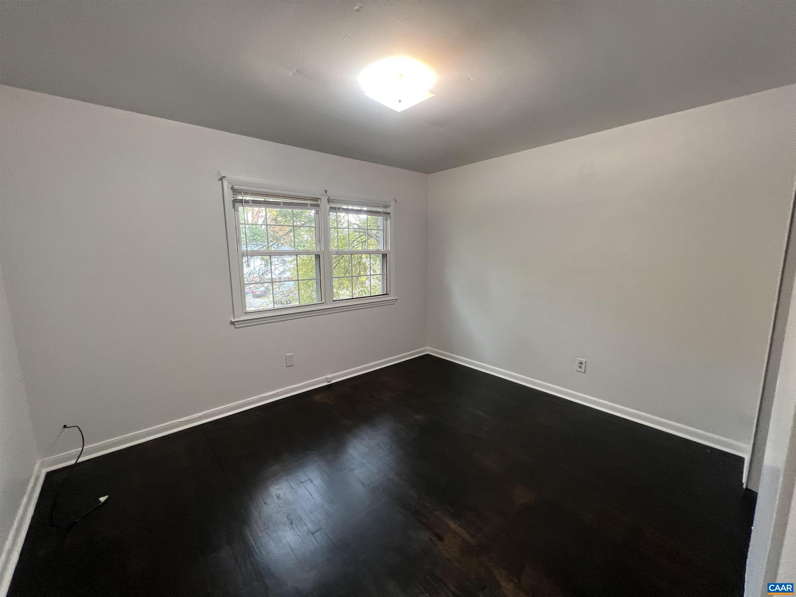 124 Middlesex Drive, Unit B Charlottesville, VA 22901 - Photo 7 of 38 a view of an empty room with wooden floor and a window
