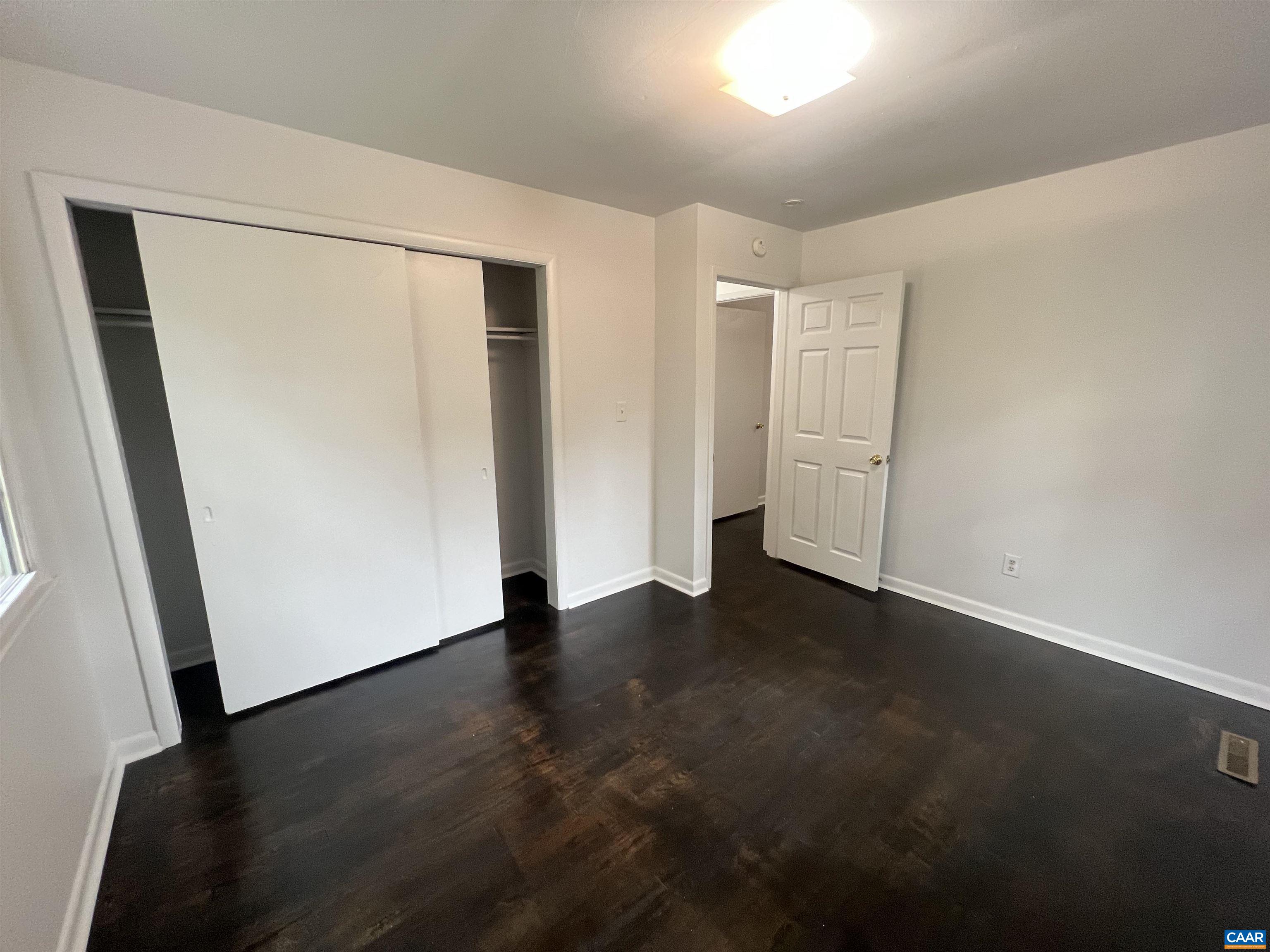 124 Middlesex Drive, Unit B Charlottesville, VA 22901 - Photo 8 of 38 an empty room with wooden floor and closet