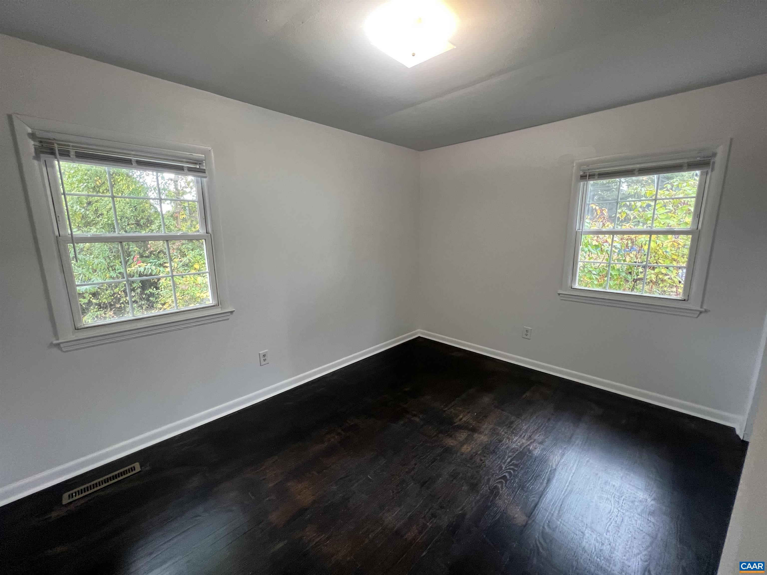 124 Middlesex Drive, Unit B Charlottesville, VA 22901 - Photo 9 of 38 a view of an empty room with wooden floor and a window
