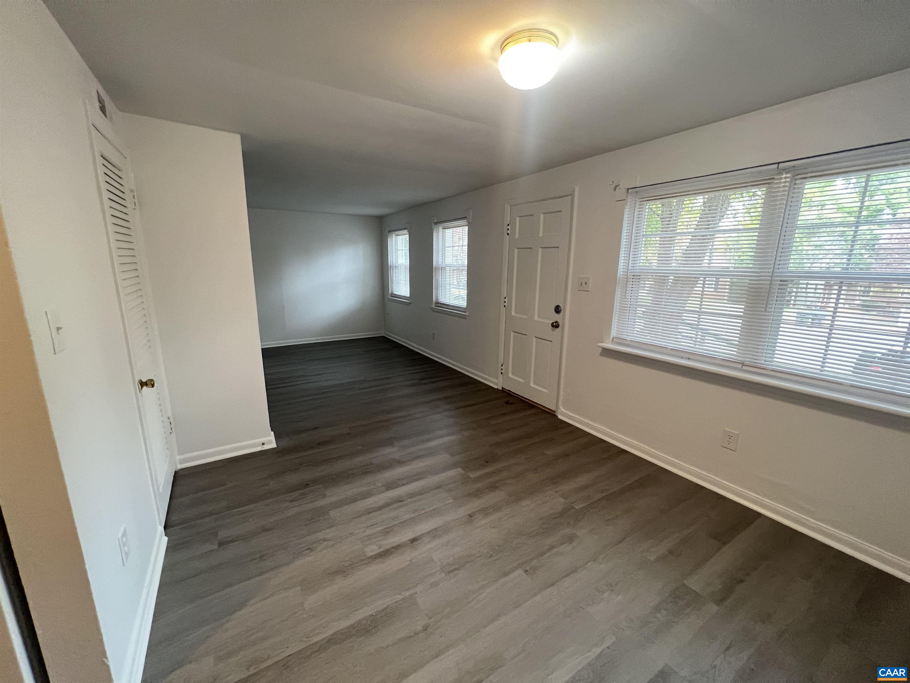 124 Middlesex Drive, Unit B Charlottesville, VA 22901 - Photo 10 of 38 a view of an empty room with wooden floor and a window