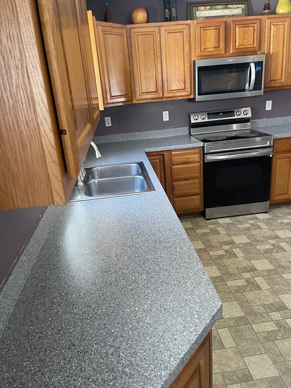 19 Annies Way Springfield, MA 01119 - Photo 33 of 41 a kitchen with stainless steel appliances granite countertop a sink stove and microwave