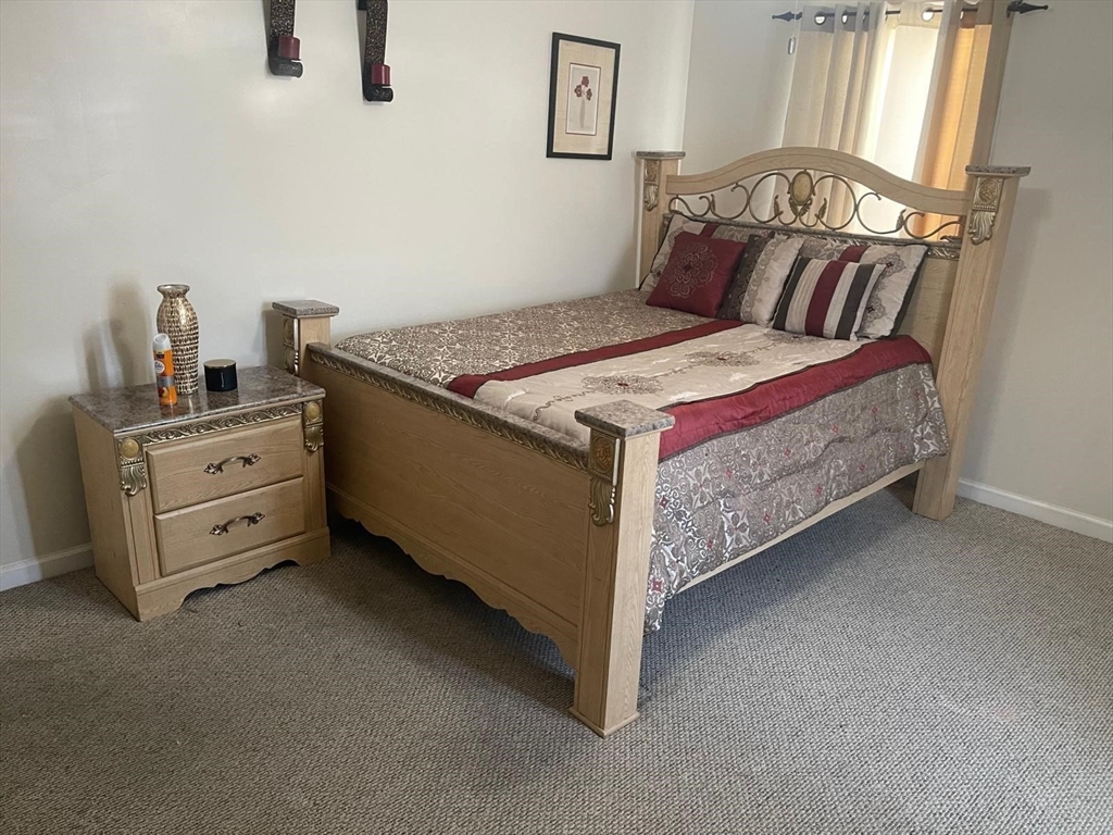 19 Annies Way Springfield, MA 01119 - Photo 5 of 41 a bed sitting in a bedroom next to a window