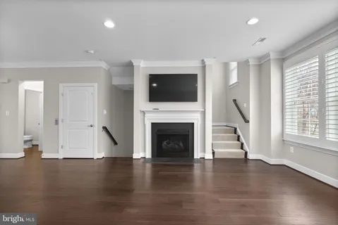 a view of a kitchen with a sink stove cabinets and empty room