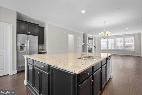 a kitchen with a stove and a wooden floor