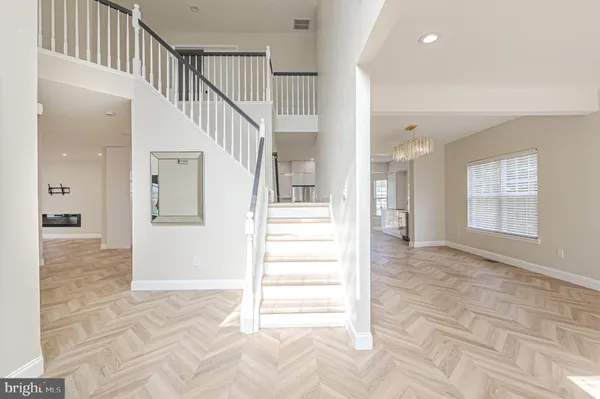a view of a hallway view with wooden floor and staircase