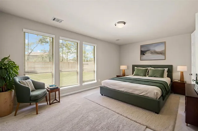 a spacious bedroom with a large bed and a large window