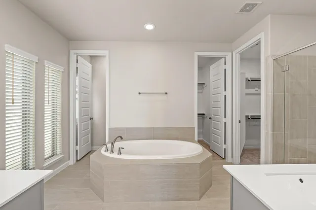 a bathroom with a bathtub and a shower