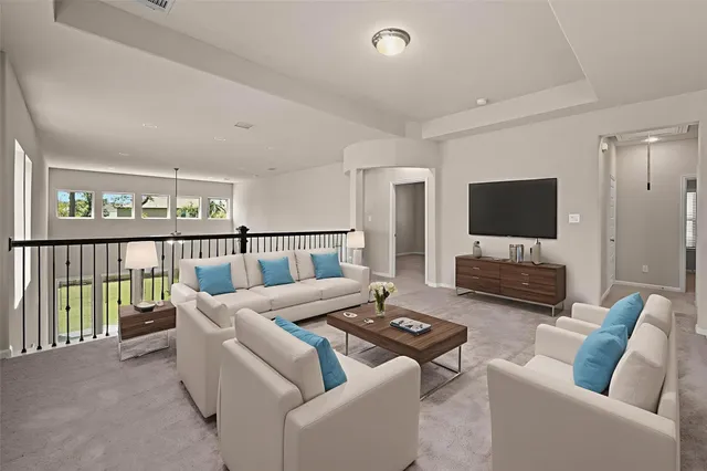 a living room with furniture a flat screen tv and a large window