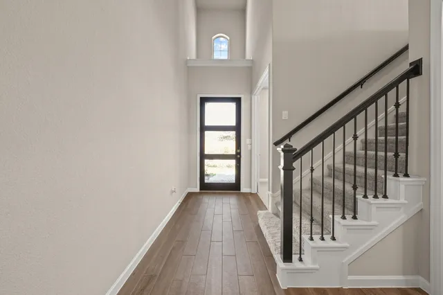 a view of hallway with wooden floor