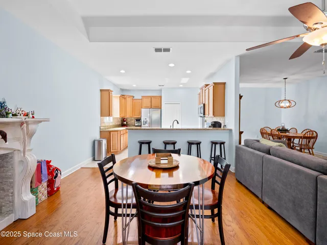 a dining room with furniture window and wooden floor