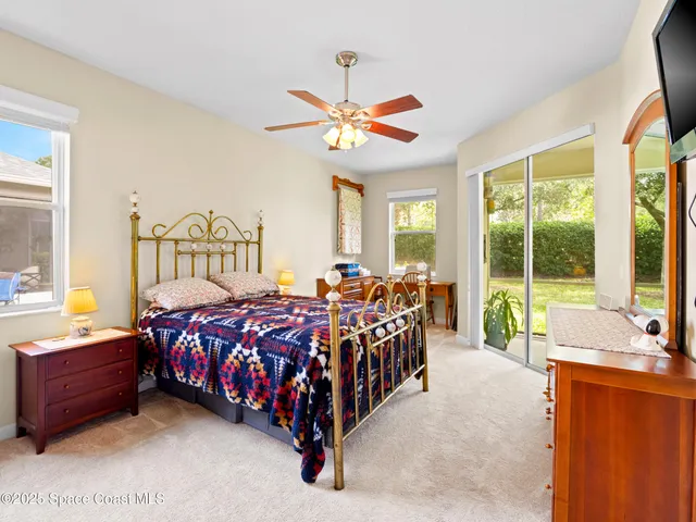 a bedroom with furniture and a book shelf