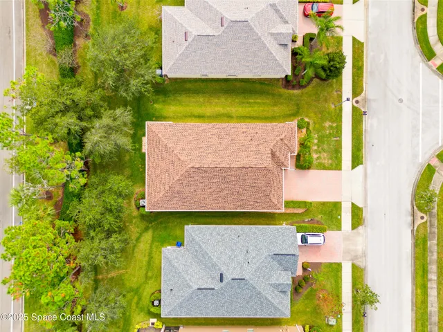 an aerial view of residential houses with outdoor space