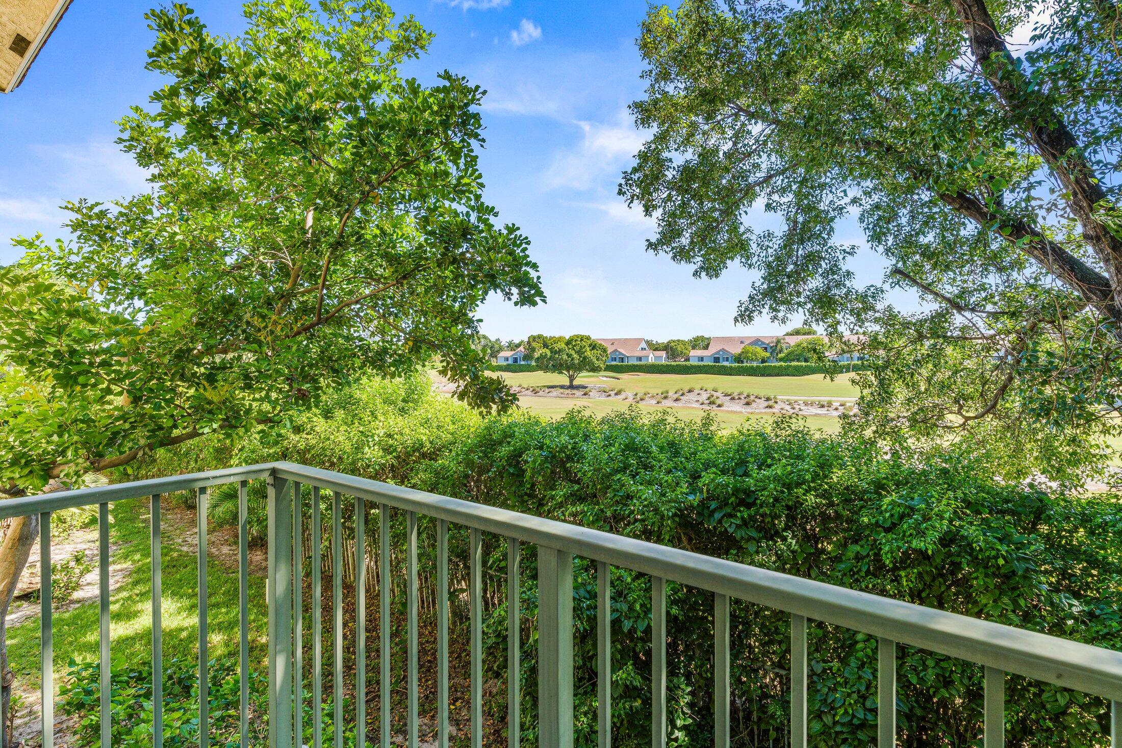 1951 Brandywine Road, Unit 59303 West Palm Beach, FL 33409 - Photo 17 of 25 a balcony with trees in front of it