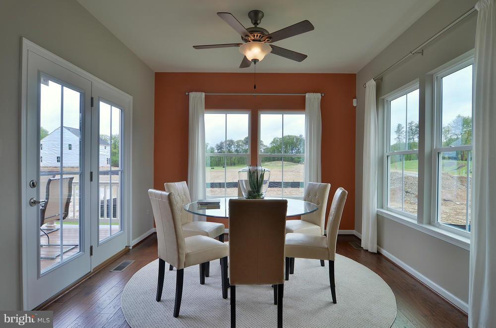 3156 Sunny Ridge Drive Odenton, MD 21113 - Photo 4 of 30 a dining room with furniture window and wooden floor