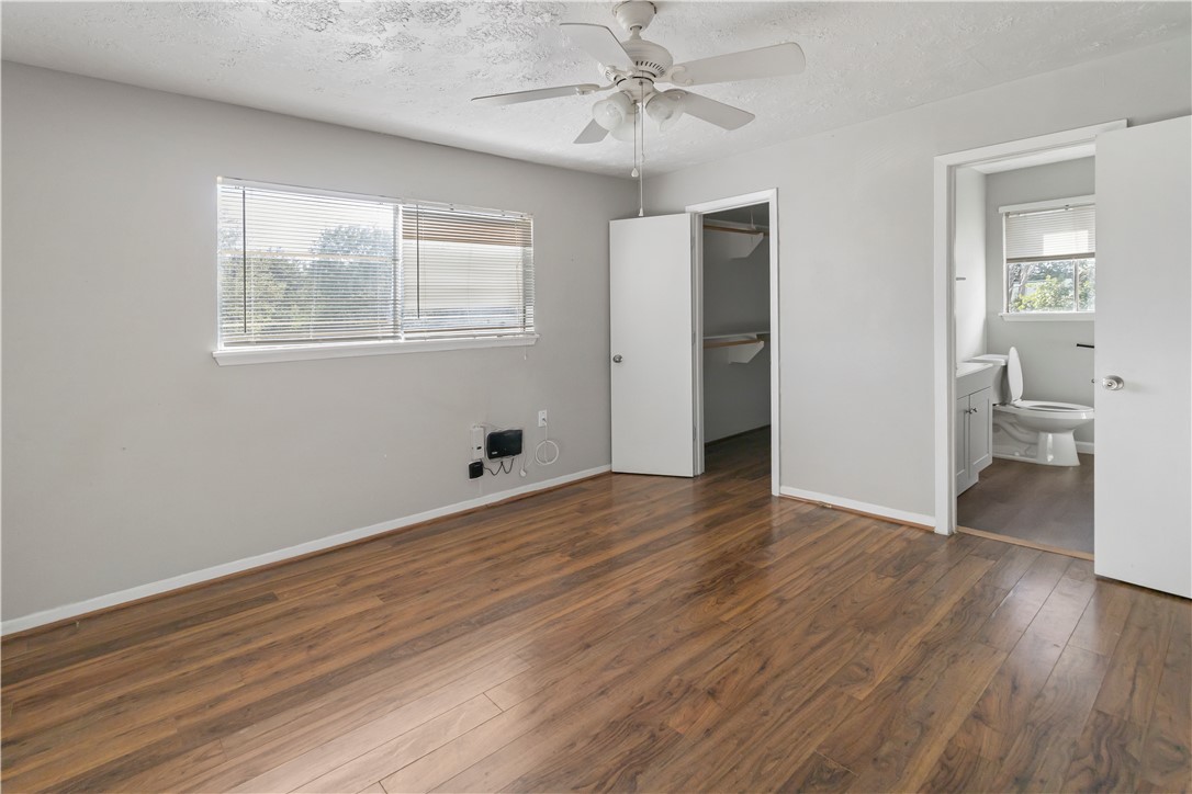 1012-1014 East 23rd Street Bryan, TX 77803 - Photo 14 of 22 a view of an empty room with a window and wooden floor