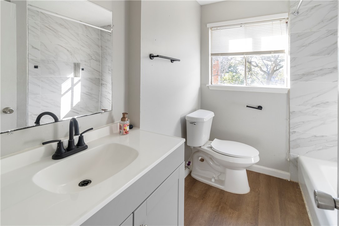 1012-1014 East 23rd Street Bryan, TX 77803 - Photo 17 of 22 a bathroom with a sink a toilet and a mirror