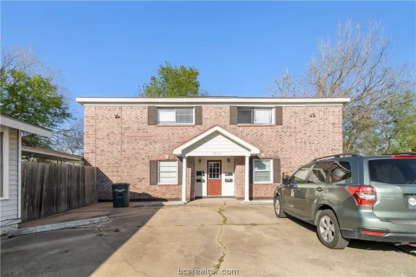a front view of a house with parking space