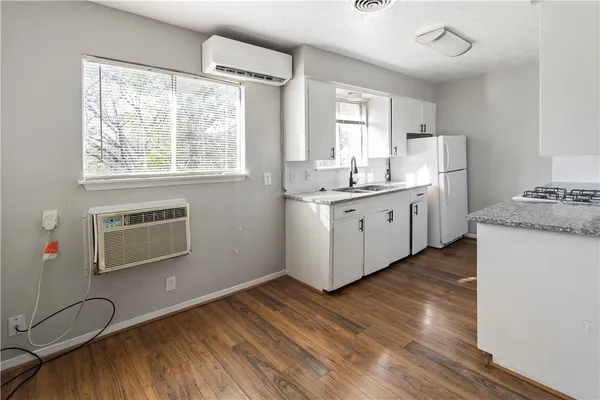 a kitchen with sink cabinets and wooden floor