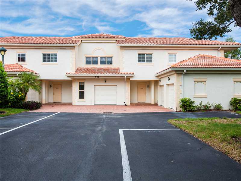 576 7th Square Southwest, Unit 202 Vero Beach, FL 32962 - Photo 1 of 28 a front view of a house with garden