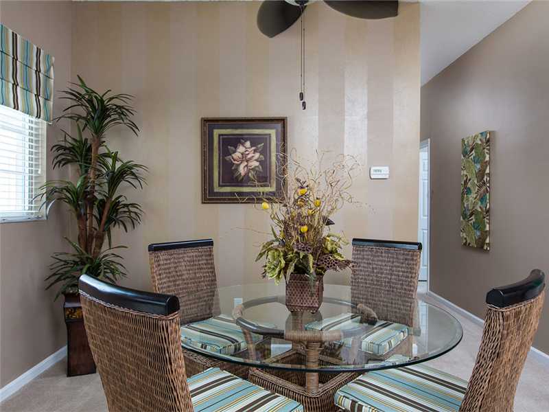 576 7th Square Southwest, Unit 202 Vero Beach, FL 32962 - Photo 11 of 28 a dining room with furniture and wooden floor