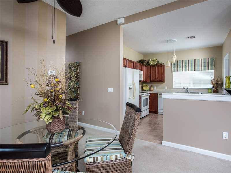 576 7th Square Southwest, Unit 202 Vero Beach, FL 32962 - Photo 12 of 28 a living room with furniture and a dining table with kitchen view