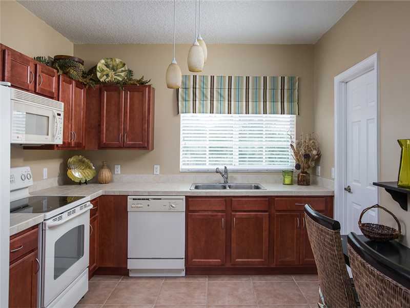 576 7th Square Southwest, Unit 202 Vero Beach, FL 32962 - Photo 13 of 28 a kitchen that has a sink and a stove