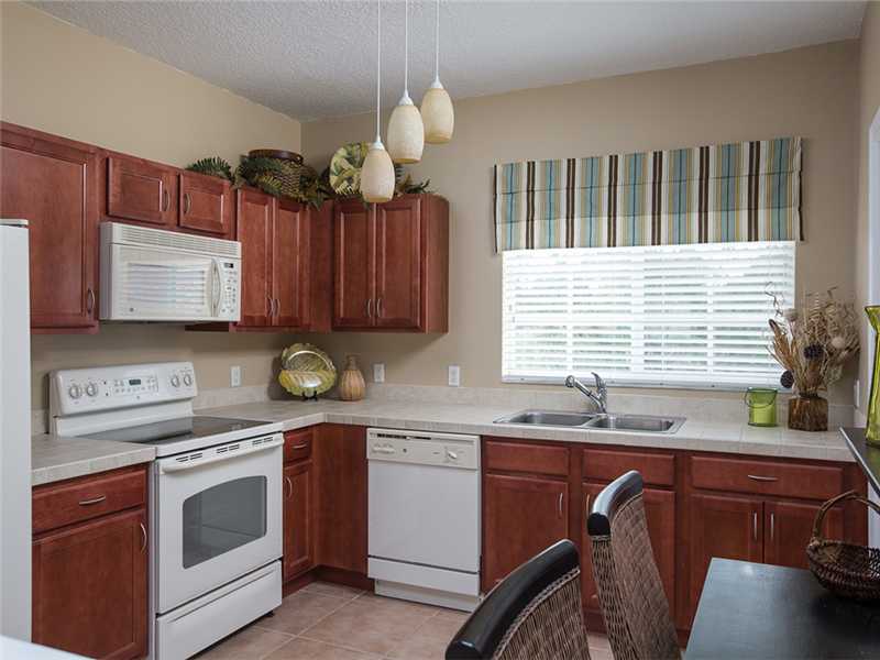 576 7th Square Southwest, Unit 202 Vero Beach, FL 32962 - Photo 14 of 28 a kitchen with a sink cabinets and window