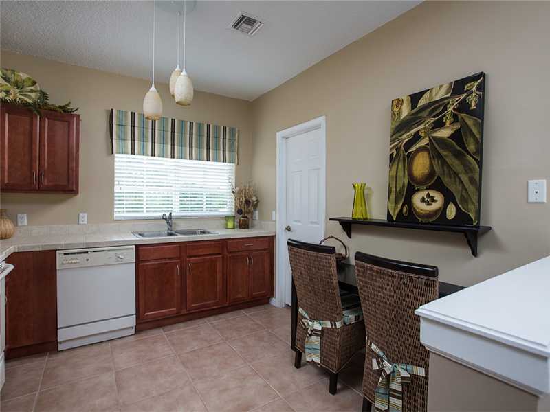 576 7th Square Southwest, Unit 202 Vero Beach, FL 32962 - Photo 15 of 28 a kitchen with granite countertop a sink cabinets and window