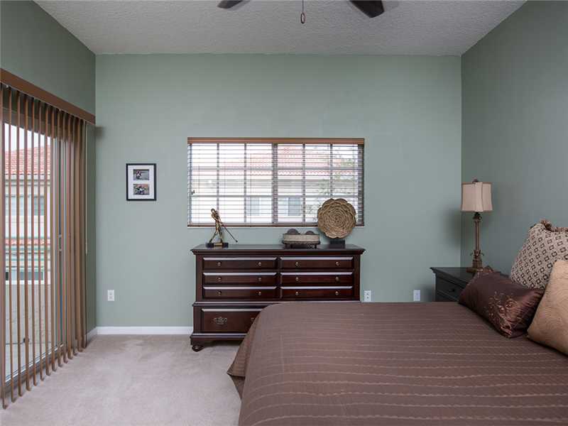 576 7th Square Southwest, Unit 202 Vero Beach, FL 32962 - Photo 17 of 28 a bedroom with a bed and window