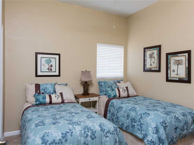 576 7th Square Southwest, Unit 202 Vero Beach, FL 32962 - Photo 18 of 28 a bedroom with two beds and a couch