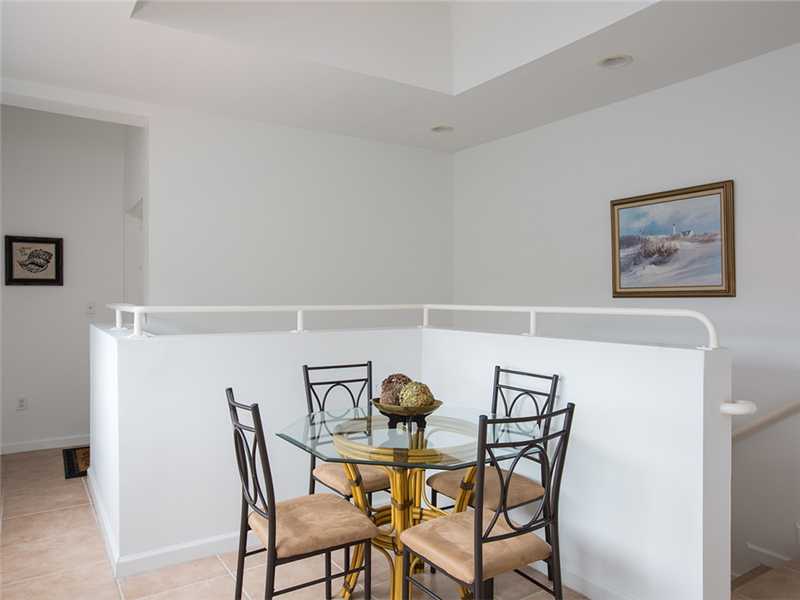 576 7th Square Southwest, Unit 202 Vero Beach, FL 32962 - Photo 19 of 28 a view of a dining room with furniture and wooden floor