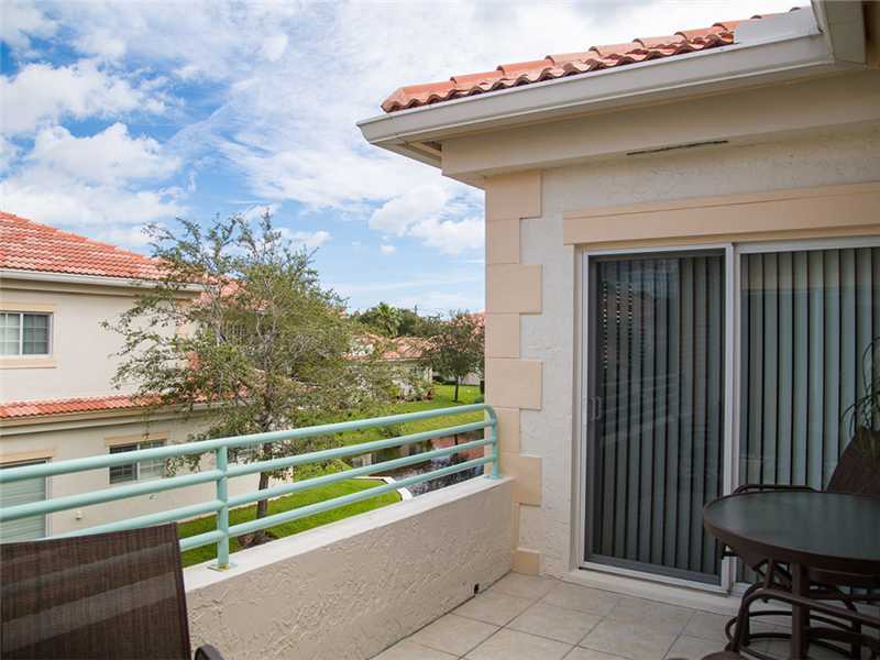 576 7th Square Southwest, Unit 202 Vero Beach, FL 32962 - Photo 21 of 28 a view of a porch with furniture and a gate