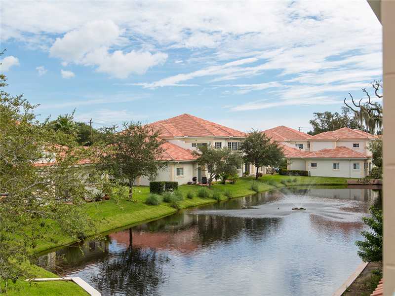 576 7th Square Southwest, Unit 202 Vero Beach, FL 32962 - Photo 22 of 28 an aerial view of residential houses with outdoor space and lake view