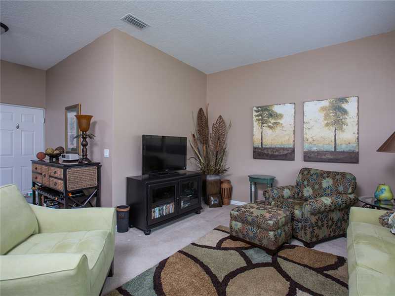 576 7th Square Southwest, Unit 202 Vero Beach, FL 32962 - Photo 3 of 28 a living room with furniture and a flat screen tv