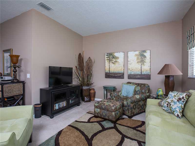 576 7th Square Southwest, Unit 202 Vero Beach, FL 32962 - Photo 4 of 28 a living room with furniture and a flat screen tv