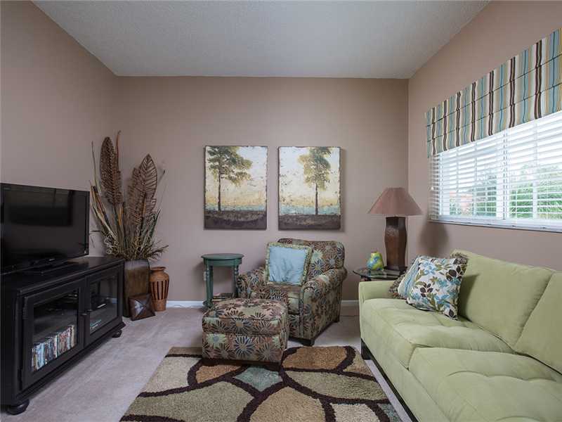 576 7th Square Southwest, Unit 202 Vero Beach, FL 32962 - Photo 6 of 28 a living room with furniture and a flat screen tv