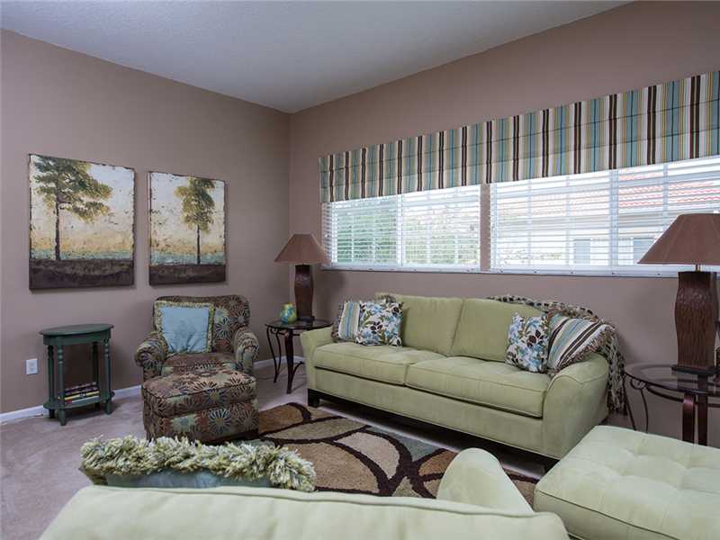 576 7th Square Southwest, Unit 202 Vero Beach, FL 32962 - Photo 7 of 28 a living room with furniture window and a fireplace