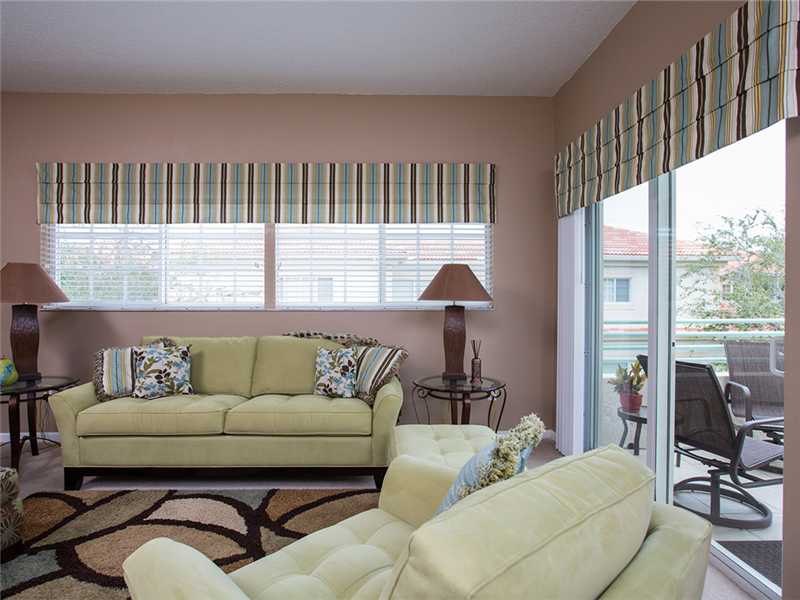 576 7th Square Southwest, Unit 202 Vero Beach, FL 32962 - Photo 8 of 28 a living room with furniture and a large window
