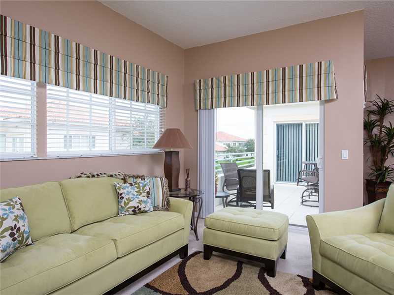 576 7th Square Southwest, Unit 202 Vero Beach, FL 32962 - Photo 9 of 28 a living room with furniture and a large window