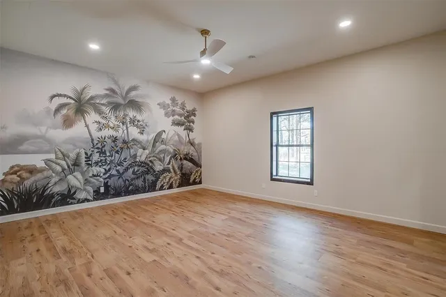 a view of a livingroom with wooden floor and entryway