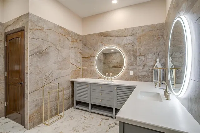 a bathroom with a sink a mirror and vanity