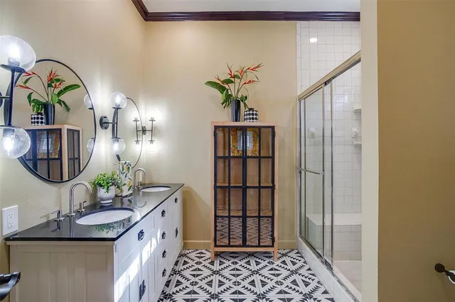 a bathroom with a sink a mirror and glass door