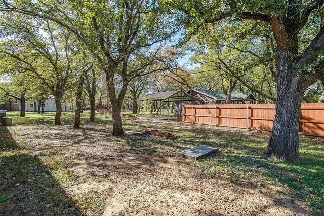 a view of a yard with a tree