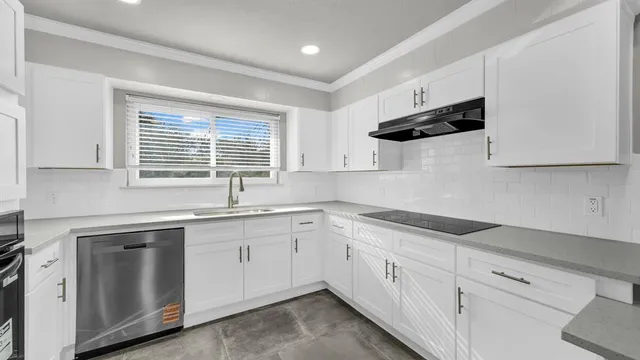 a kitchen with white cabinets white appliances and sink